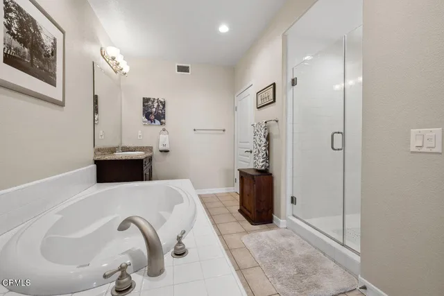 a spacious bathroom with a tub and a sink