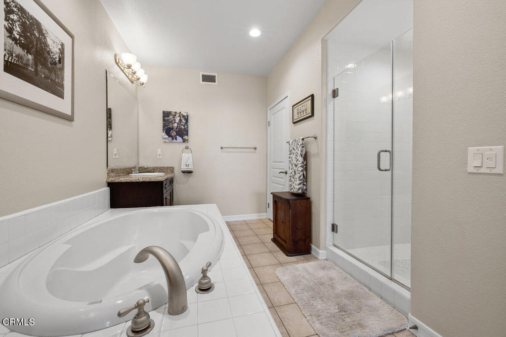 1544 Seabridge Lane Oxnard, CA 93035 - Photo 23 of 30 a spacious bathroom with a tub and a sink