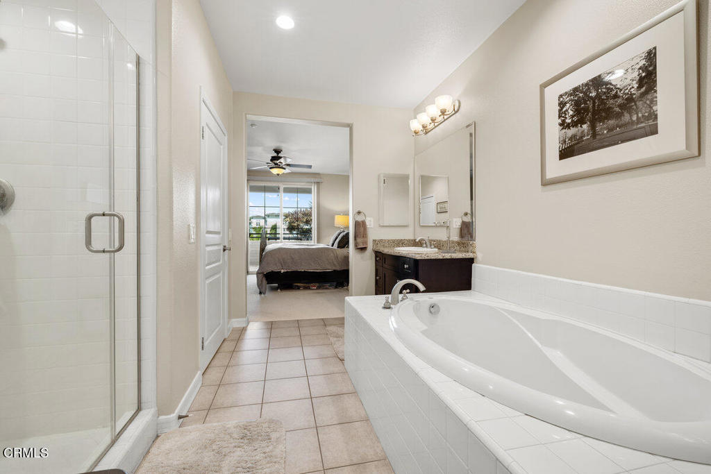 1544 Seabridge Lane Oxnard, CA 93035 - Photo 24 of 30 a bathroom with a tub a sink and mirrors