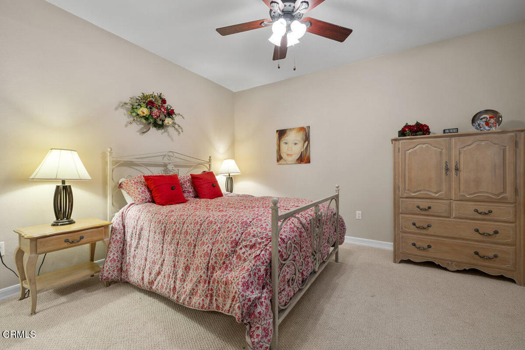 1544 Seabridge Lane Oxnard, CA 93035 - Photo 25 of 30 a bedroom with a bed and a chandelier