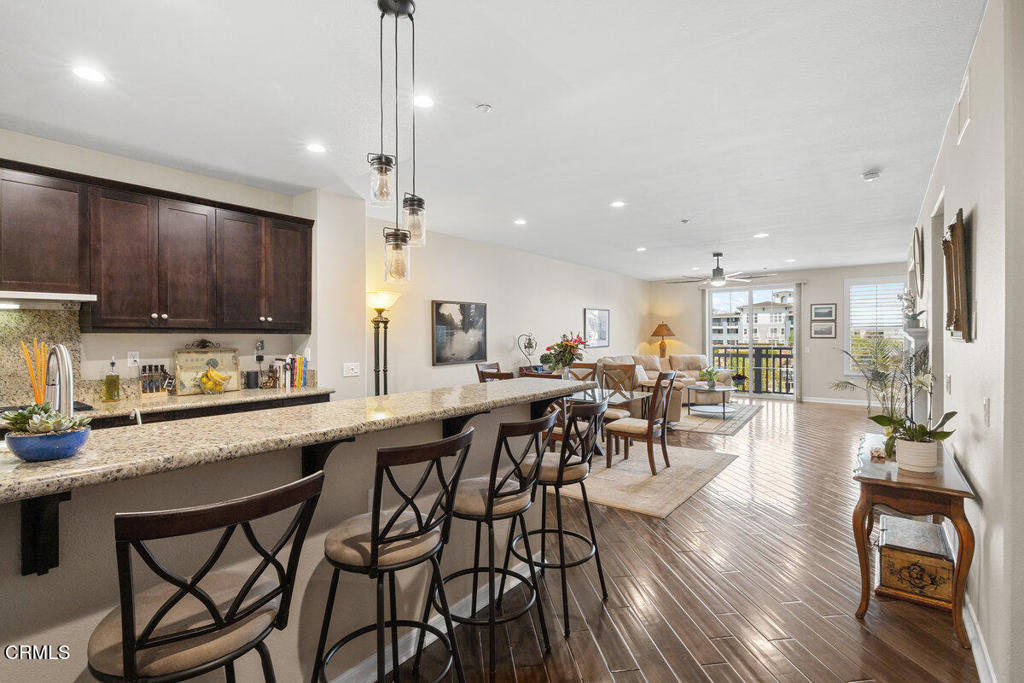 1544 Seabridge Lane Oxnard, CA 93035 - Photo 6 of 30 a kitchen with stainless steel appliances granite countertop table chairs stove and cabinets
