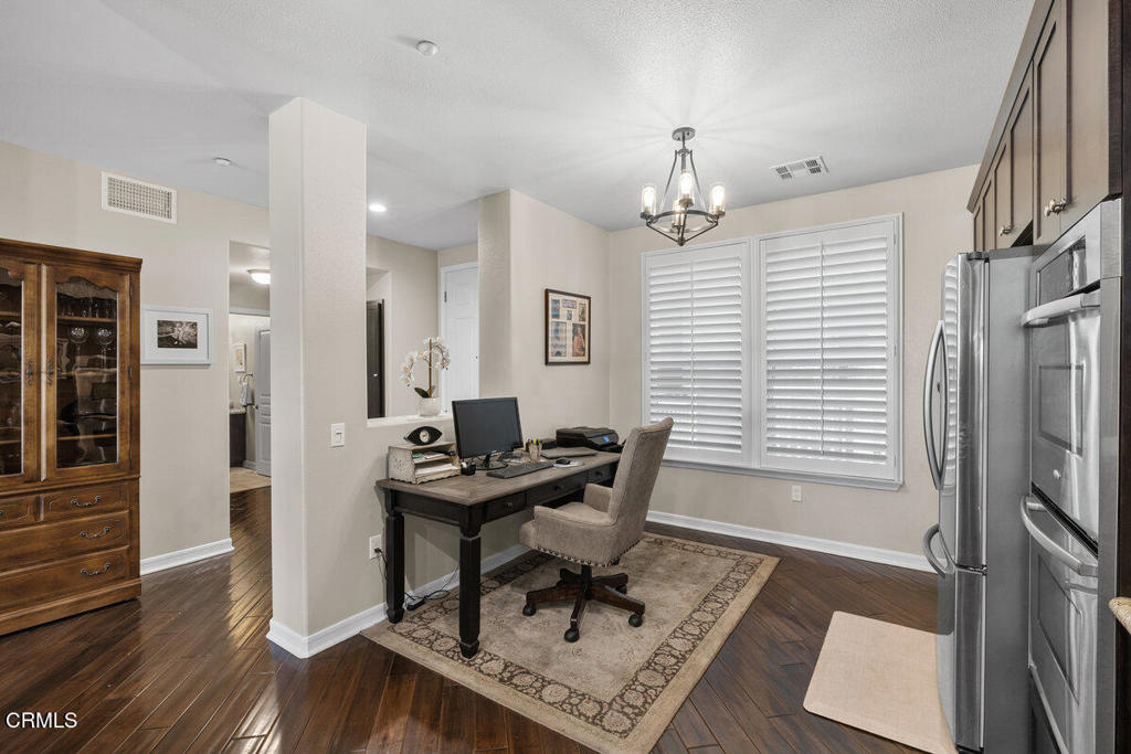 1544 Seabridge Lane Oxnard, CA 93035 - Photo 8 of 30 a view of a workspace with furniture and wooden floor