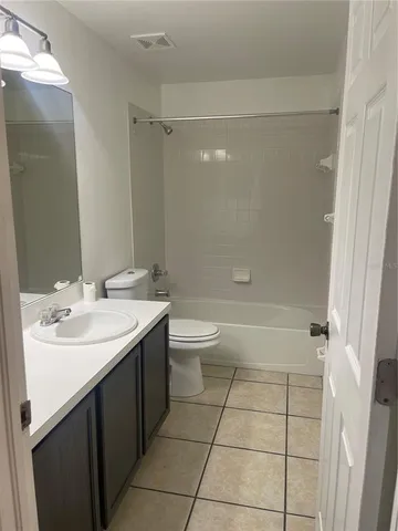 an empty room with wooden floor and closet