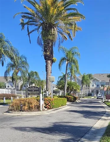 a view of a city street lined with buildings and trees