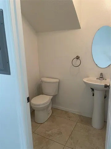 a living room with stainless steel appliances kitchen island granite countertop a sink and cabinets