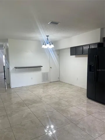 a kitchen with stainless steel appliances granite countertop a refrigerator a stove a sink and a microwave