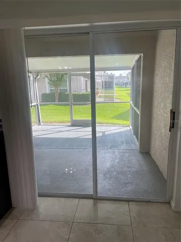 a view of a living room with furniture and windows