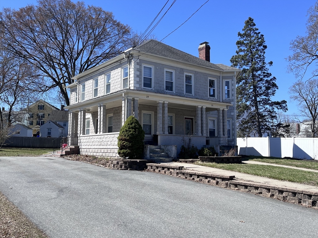 29-31 Middlesex Street, Unit 1 Chelmsford, MA 01863 - Photo 1 of 31 front view of a house with a yard