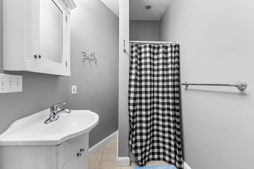 29-31 Middlesex Street, Unit 1 Chelmsford, MA 01863 - Photo 19 of 31 a bathroom with a sink and a shower