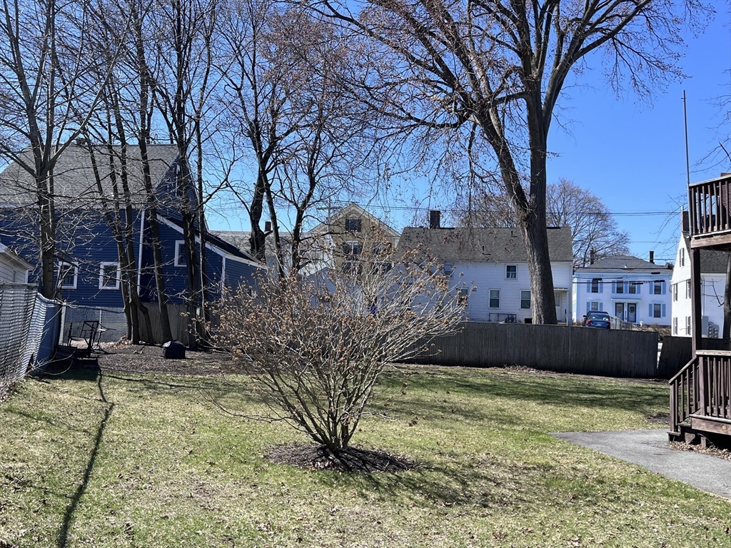 29-31 Middlesex Street, Unit 1 Chelmsford, MA 01863 - Photo 2 of 31 a view of a yard with plants and a tree