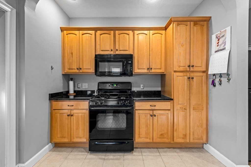 29-31 Middlesex Street, Unit 1 Chelmsford, MA 01863 - Photo 4 of 31 a kitchen with a stove and a microwave