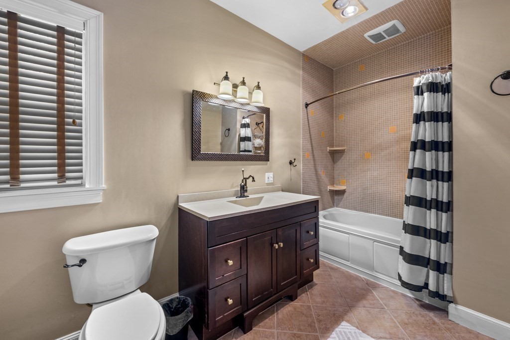 29-31 Middlesex Street, Unit 1 Chelmsford, MA 01863 - Photo 9 of 31 a bathroom with a toilet sink and mirror