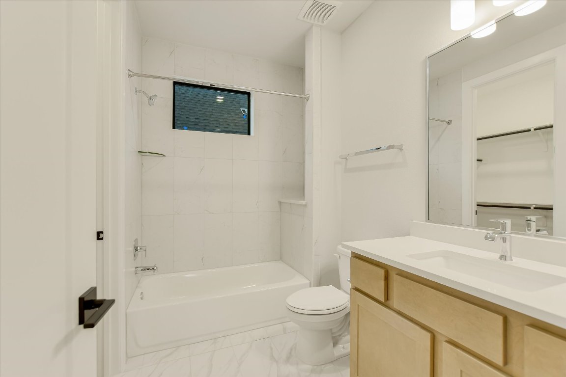 114 Lightsey Road, Unit 1 Austin, TX 78704 - Photo 24 of 25 a bathroom with a sink a toilet and shower