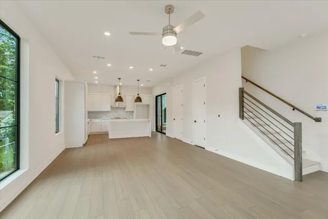 a view of a livingroom with a ceiling fan and window