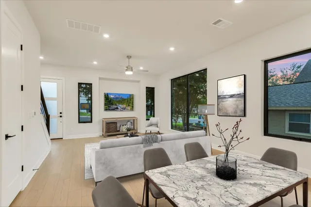 a living room with fireplace furniture and a large window