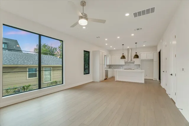 a view of a livingroom with furniture wooden floor and window
