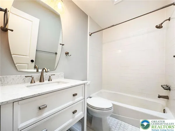 a bathroom with a sink a toilet and a bathtub
