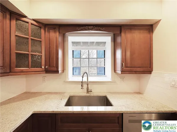 a close view of a sink and dishwasher in a kitchen
