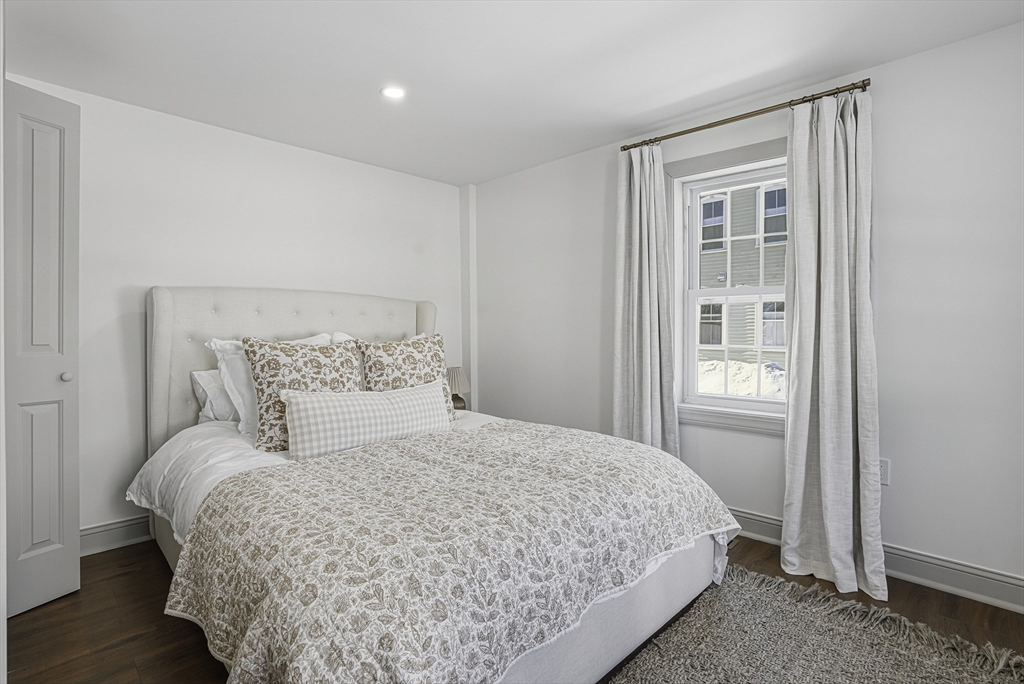 26 Maple Street Mendon, MA 01756 - Photo 26 of 42 a bedroom with a bed and wooden floor