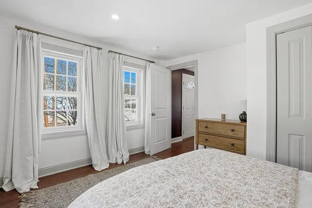 an empty room with closet and windows