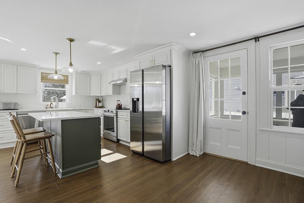 26 Maple Street Mendon, MA 01756 - Photo 4 of 42 a kitchen with a refrigerator a microwave and wooden floor