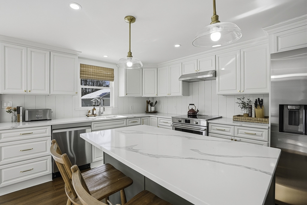 26 Maple Street Mendon, MA 01756 - Photo 8 of 42 a kitchen with a stove a window and chairs