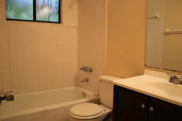a bathroom with a sink a toilet and bathtub