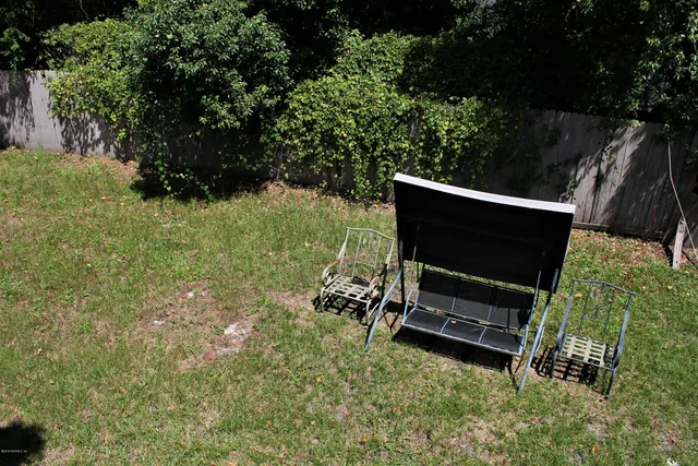 a backyard of a house with yard and outdoor seating
