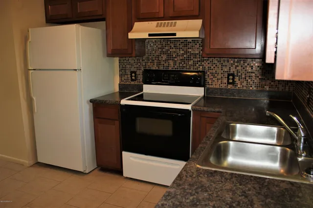 a kitchen with cabinets and stainless steel appliances