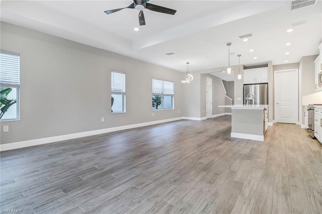 4652 Centaurus Circle Naples, FL 34120 - Photo 12 of 45 Unfurnished living room with ceiling fan, recessed lighting, and light wood finished floors