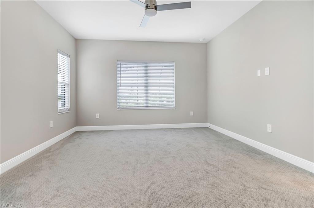4652 Centaurus Circle Naples, FL 34120 - Photo 15 of 45 Spare room featuring ceiling fan and light colored carpet