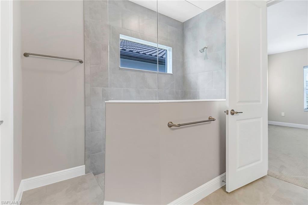 4652 Centaurus Circle Naples, FL 34120 - Photo 17 of 45 Full bathroom with baseboards and a walk in shower
