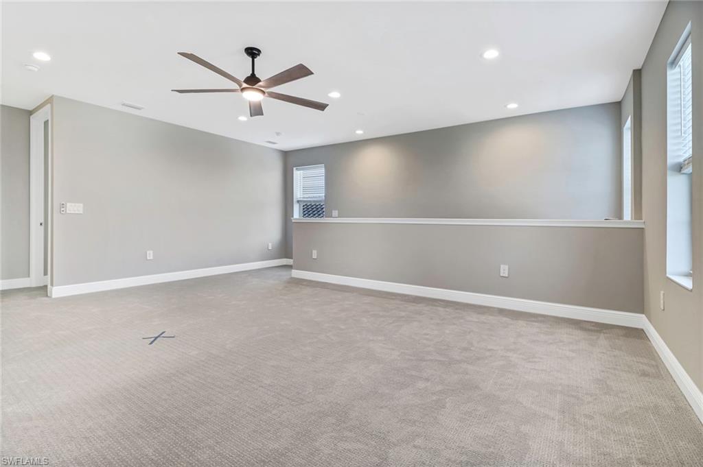 4652 Centaurus Circle Naples, FL 34120 - Photo 19 of 45 Empty room with a ceiling fan, recessed lighting, and light carpet
