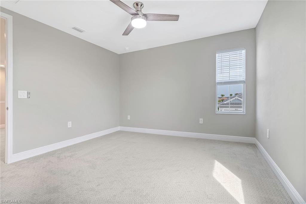 4652 Centaurus Circle Naples, FL 34120 - Photo 21 of 45 Spare room featuring light carpet and a ceiling fan