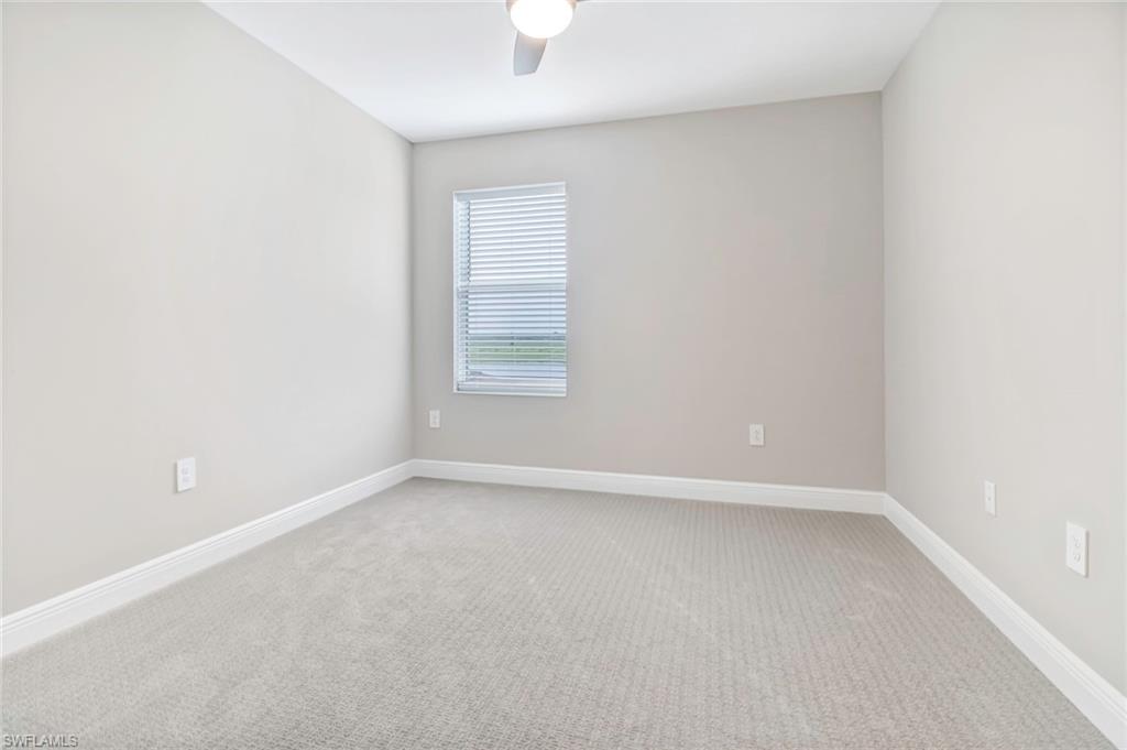 4652 Centaurus Circle Naples, FL 34120 - Photo 23 of 45 Empty room with light carpet and a ceiling fan