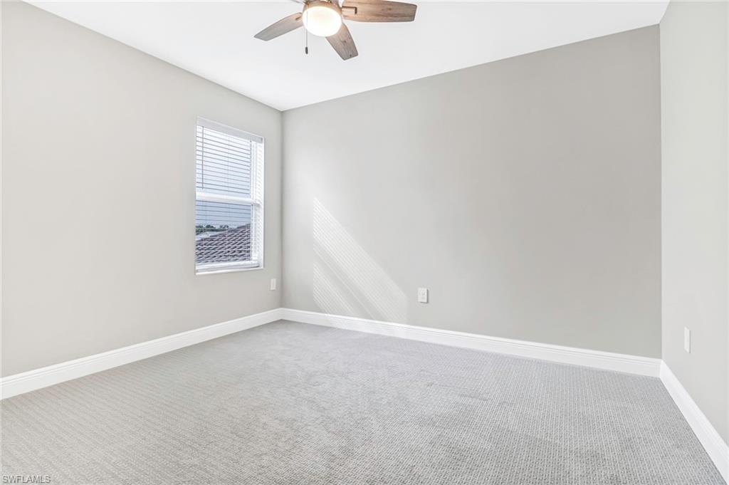 4652 Centaurus Circle Naples, FL 34120 - Photo 25 of 45 Empty room featuring carpet floors and a ceiling fan