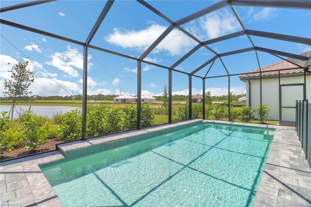 4652 Centaurus Circle Naples, FL 34120 - Photo 32 of 45 Swimming pool with a sunroom and glass enclosure