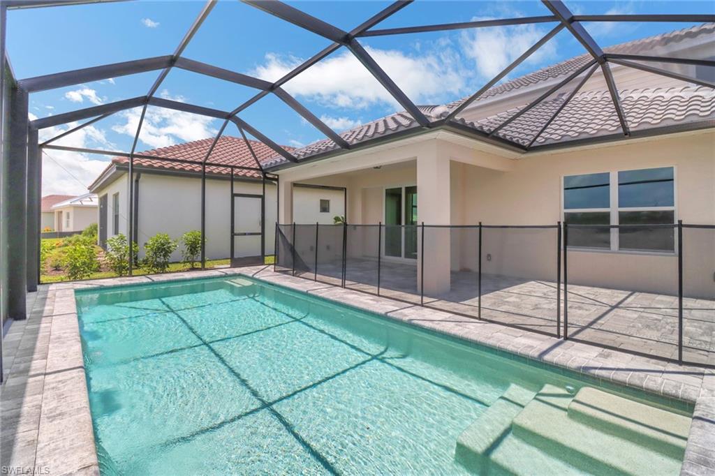 4652 Centaurus Circle Naples, FL 34120 - Photo 33 of 45 Outdoor pool featuring a sunroom, glass enclosure, and a patio area
