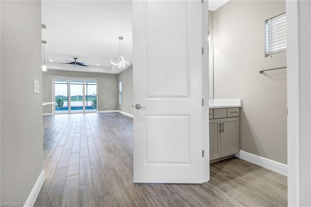 4652 Centaurus Circle Naples, FL 34120 - Photo 9 of 45 Hallway with wood tiled floors and recessed lighting