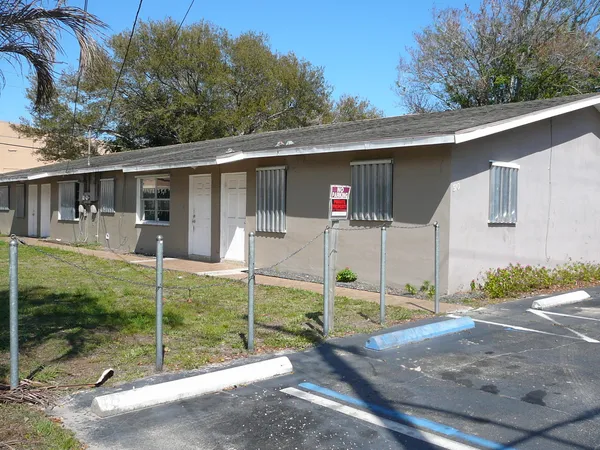 a view of a house with a backyard and porch