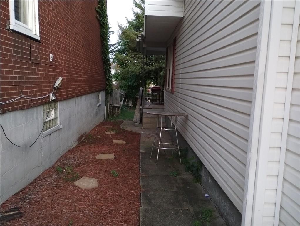 803 11th Street McKees Rocks, PA 15136 - Photo 3 of 14 a backyard of a house with table and chairs
