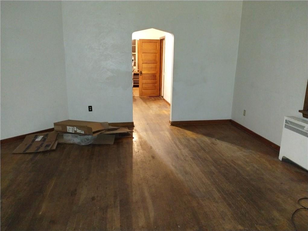 803 11th Street McKees Rocks, PA 15136 - Photo 4 of 14 a view of an empty room with wooden floor and a window