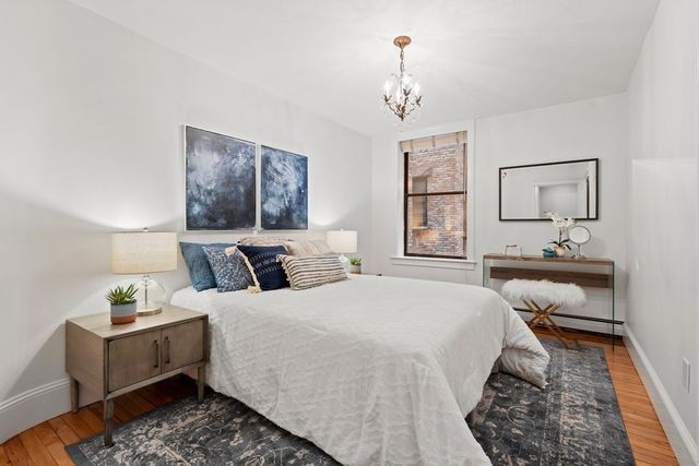 a bedroom with bed and window