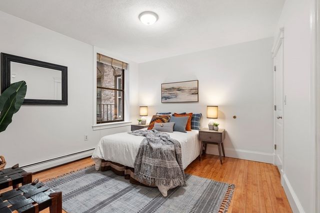 a bed room with a bed and a window