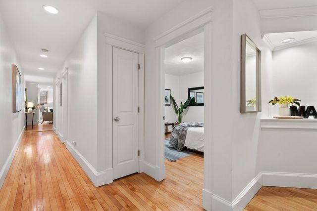 a view of a hallway view with wooden floor and furniture