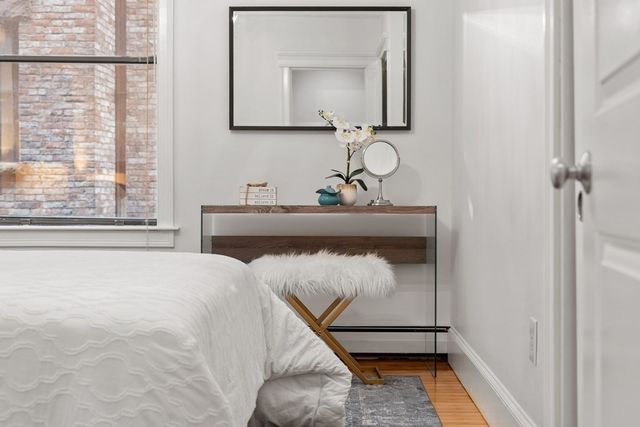 a bedroom with a bed and a mirror