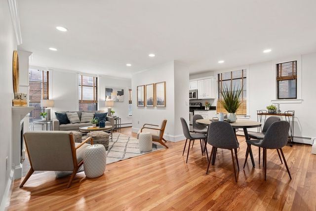 a living room with furniture a wooden floor and a window