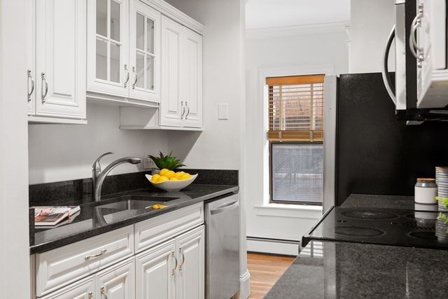 a kitchen with stainless steel appliances granite countertop a sink and cabinets