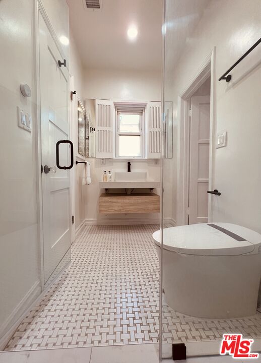 6187 Barrows Drive Los Angeles, CA 90048 - Photo 16 of 35 a bathroom with a bathtub and a shower