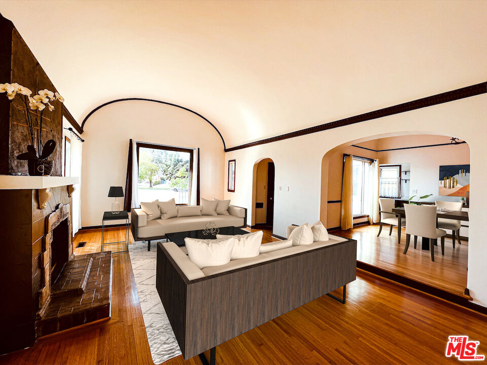 6187 Barrows Drive Los Angeles, CA 90048 - Photo 2 of 35 a living room with fireplace furniture and a flat screen tv